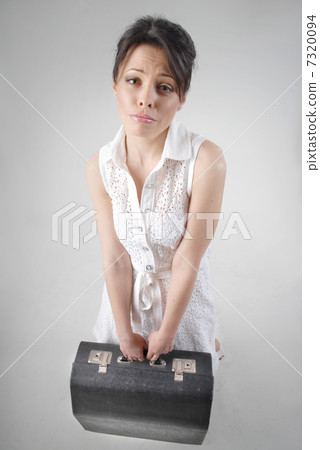 begging brunette with travel bag in white dress begging brunette with travel bag in white dress 7320094