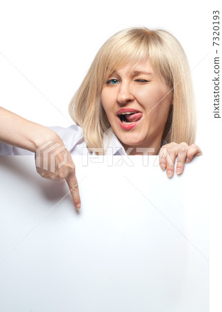Attractive funny woman holding white empty paper and pointing on Attractive funny woman holding white empty paper and pointing on 7320193
