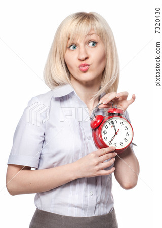 A beautiful young woman with alarm clock isolated on white 7320430