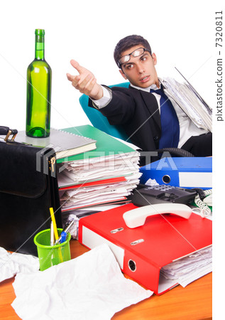 Young busy businessman at his desk Young busy businessman at his desk 7320811