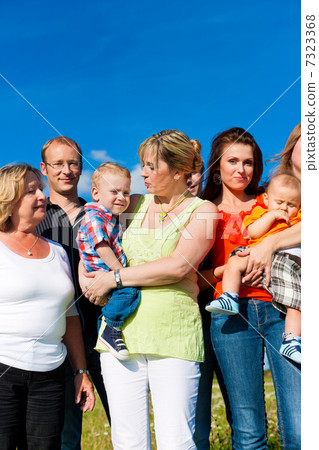 Family and multi-generation - fun on meadow in summer 7323368