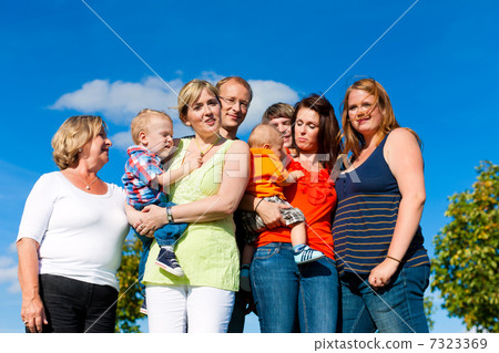 Family and multi-generation - fun on meadow in summer 7323369