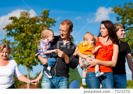 Family and multi-generation - fun on meadow in summer 7323370