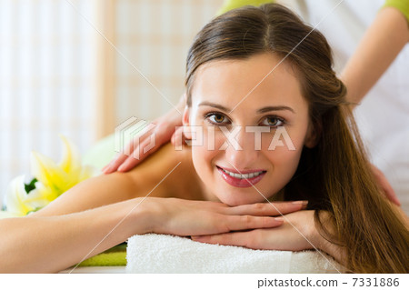 woman having a wellness back massage woman having a wellness back massage 7331886