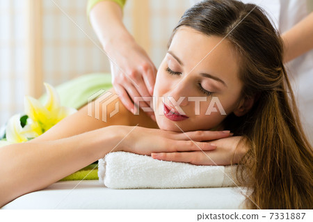 woman having a wellness back massage woman having a wellness back massage 7331887