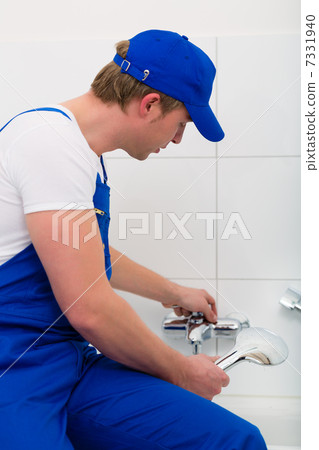 Plumber repairing shower in bath room Plumber repairing shower in bath room 7331940