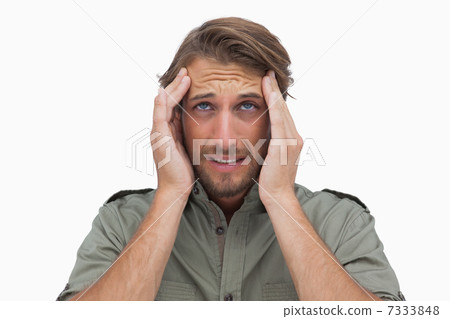 Man grimacing with pain of headache and looking up Man grimacing with pain of headache and looking up 7333848