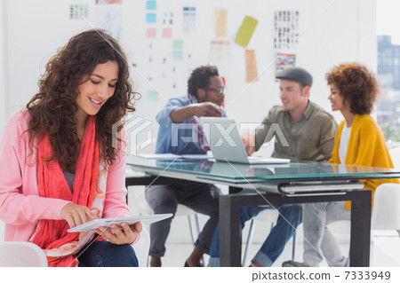 Smiling designer using digital tablet 7333949