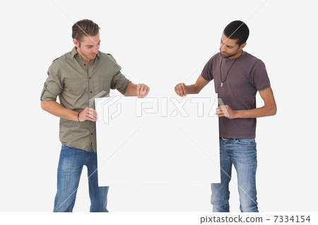Attractive men holding blank card and looking at it Attractive men holding blank card and looking at it 7334154