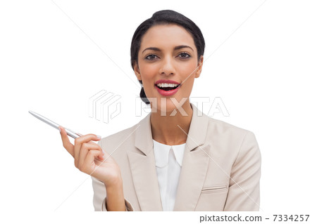Smiling businesswoman holding a pen Smiling businesswoman holding a pen 7334257