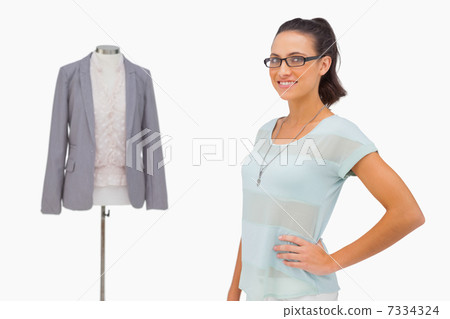 Designer smiling beside her mannequin 7334324