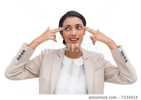 Confident young businesswoman pointing her head with her fingers Confident young businesswoman pointing her head with her fingers 7334818