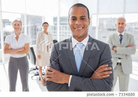Smiling businessman with arms crossed 7334880