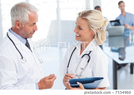 Two doctors speaking to each other Two doctors speaking to each other 7334960