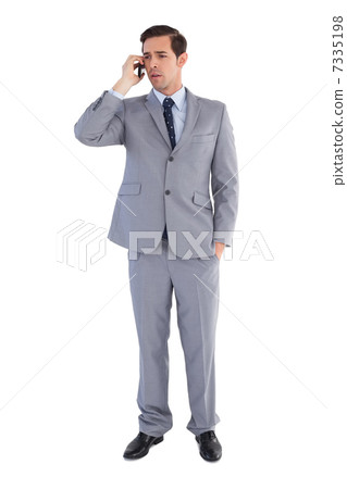 Businessman confused while being on the phone 7335198