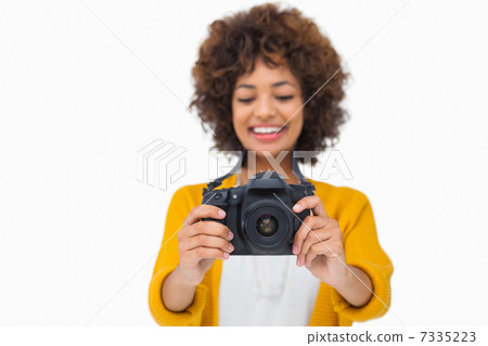 Attractive girl holding a camera 7335223