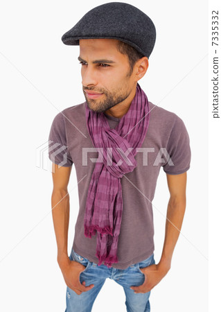Thougthful man wearing peaked cap and scarf Thougthful man wearing peaked cap and scarf 7335332