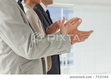 Business people applauding together 7335384