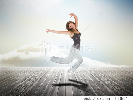 Woman jumping over wooden boards Woman jumping over wooden boards 7336041