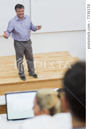 Explaining teacher standing in a lecture hall Explaining teacher standing in a lecture hall 7336158
