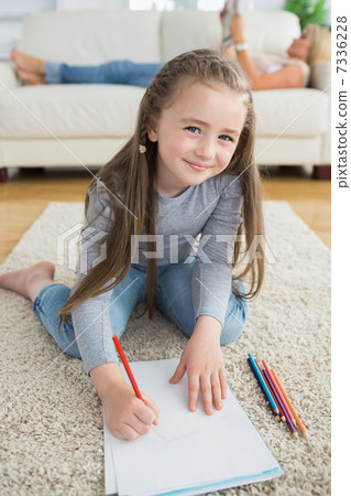 Happy girl drawing with her mother reading newspaper Happy girl drawing with her mother reading newspaper 7336228