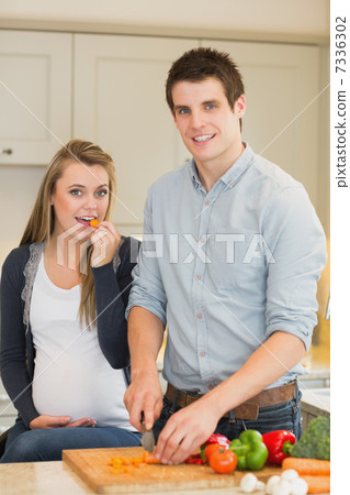 Pregnant woman eating vegetables prepared by husband Pregnant woman eating vegetables prepared by husband 7336302