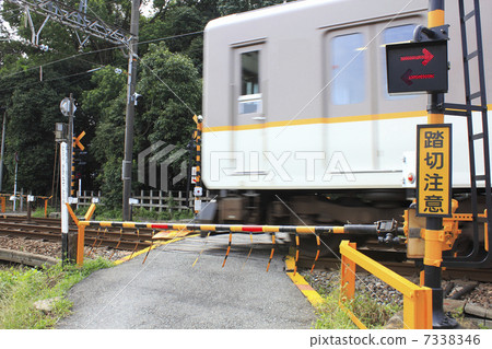 A railroad crossing through which a train passes and a breaker A railroad crossing through which a train passes and a breaker 7338346