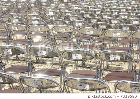 Many rows of auditorium pipe chairs 7339580