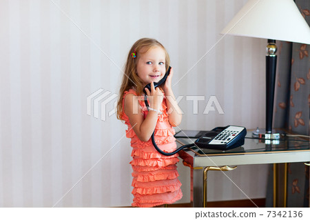 Little girl talking on phone 7342136