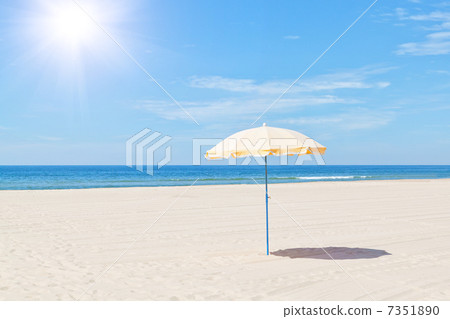 The only beach umbrella on the sea in summer under the sun. 7351890