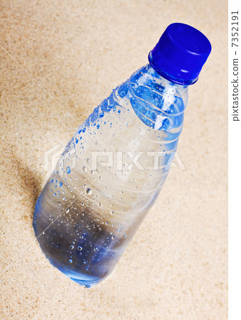 bottle of water on the hot sand 7352191