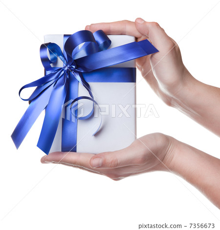 Hands holding gift in package with blue ribbon isolated on white Hands holding gift in package with blue ribbon isolated on white 7356673