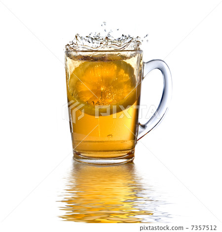 lemon dropped into tea cup with splash and reflection isolated o lemon dropped into tea cup with splash and reflection isolated o 7357512