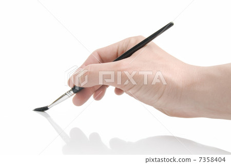 Hand holding brush isolated on white 7358404
