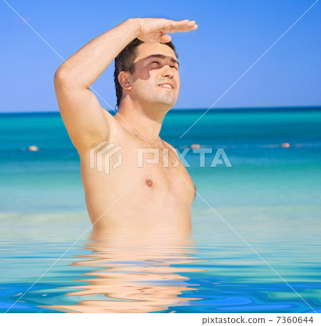 happy tanned man on the beach 7360644