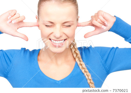 smiling woman with fingers in ears smiling woman with fingers in ears 7370021