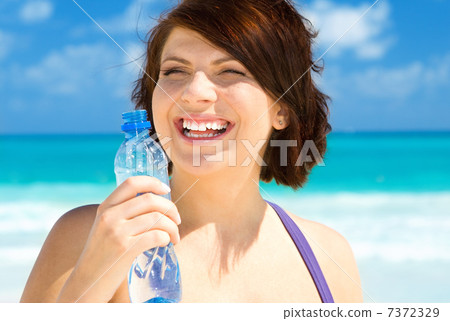 happy woman with bottle of water happy woman with bottle of water 7372329