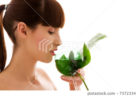 woman with green leaf and glass of water woman with green leaf and glass of water 7372334