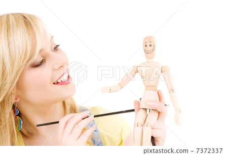 happy teenage girl with wooden model dummy happy teenage girl with wooden model dummy 7372337