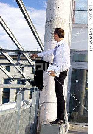 handsome businessman with laptop computer on a building site 7375051