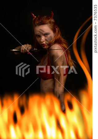 dark red devil girl with a knife in fire 7376535