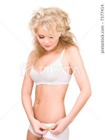 young beautiful woman with measure tape young beautiful woman with measure tape 7377414