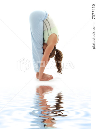 uttanasana standing forward bend on white sand 7377430