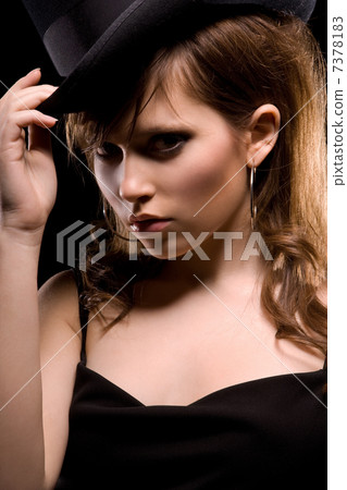 woman in black dress and top hat 7378183