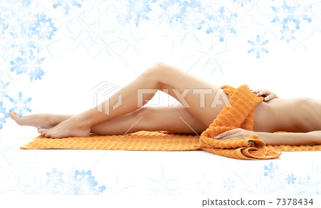 long legs of relaxed lady with orange towel 7378434