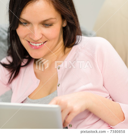 Portrait of woman using laptop at home Portrait of woman using laptop at home 7380858