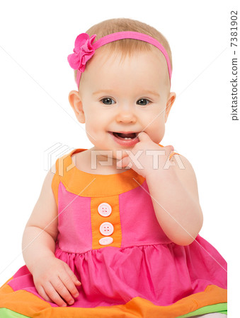 happy little sly baby girl in bright multicolored festive dress 7381902