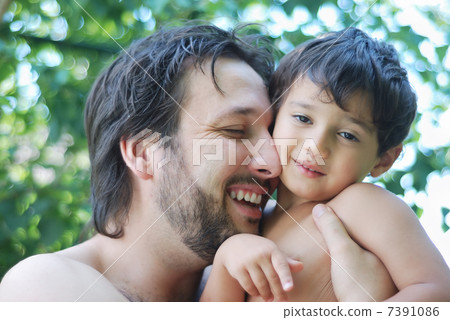 Lovely boy and his father holding him in hands in nature Lovely boy and his father holding him in hands in nature 7391086