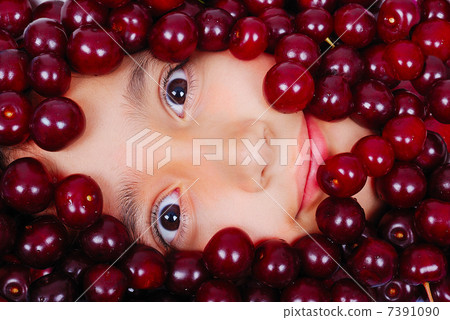 A cute girl under many pieces of cherry A cute girl under many pieces of cherry 7391090