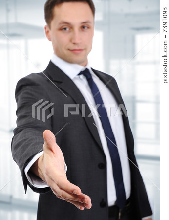 Business man shake hand and greeting you, inside the modern office. Business man shake hand and greeting you, inside the modern office. 7391093